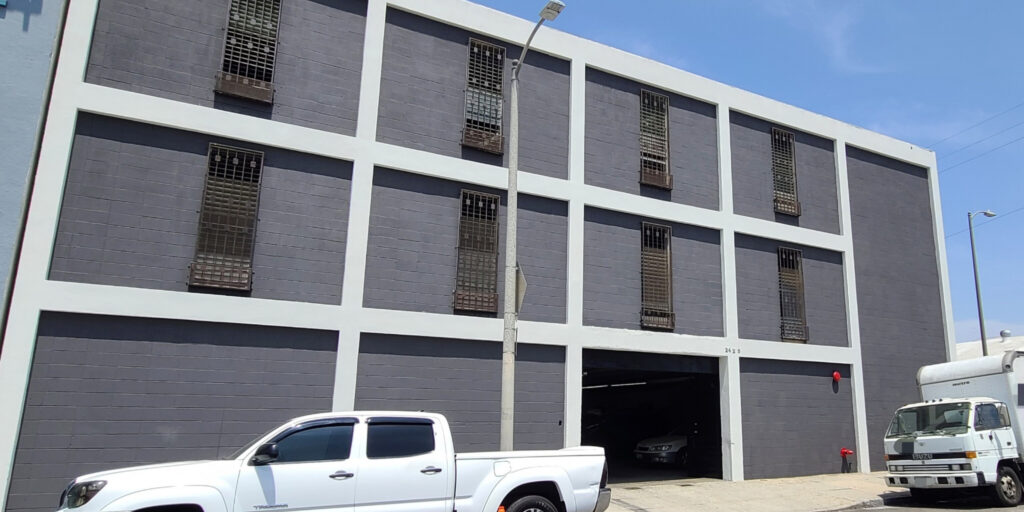 Industrial/manufacturing building freshly painted with white trims and gray brick walls in Los Angeles